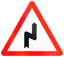 Fototapete - Chinese road sign used in Macau - Curve to the right and then to the left