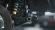 © Vyatcheslav - Car suspension system with shock absorber and control arm close-up