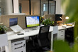 © Wavebreak Media - Workspace featuring monitors showing wind turbines, with devices, decor, seating by fabric divider