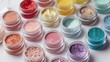 © Juan - Cosmetic pigment jars arranged in rows for beauty makeup product palette color spectrum presentation photography