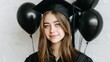© MKS - Image of a happy young student in a graduation hat, accompanied by air balloons