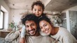 © Johannes - Cheerful african mother and indian father playing with son at home. Cute boy enjoying sitting on father shoulder while looking at camera. Middle eastern family having fun together on the sofa at home