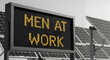 © SHERLY - Men at work LED signage with solar panels represents industrial activity and energy generation