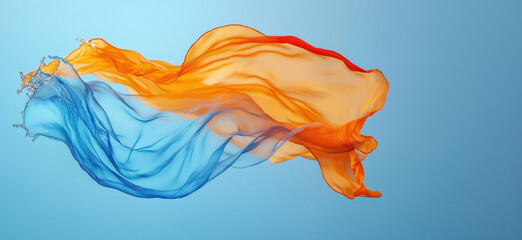 Poster - Flowing silk fabric in vibrant orange and blue colors against soft blue background.