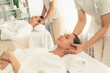 © InfiniteFlow - Caucasian couple enjoying relaxing anti-stress head massage and pampering facial beauty skin recreation leisure in dayspa modern light ambient at luxury resort or hotel spa salon. Quiescent