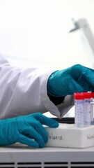 Aufkleber - Blue spot of light against mid section of caucasian female scientist putting test-tubes in a machine