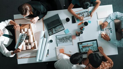Poster - Architect team discussing and pointing and presenting blueprint to interior designer. Aerial view professional business people brainstorming building interior at table with house model. Alimentation.