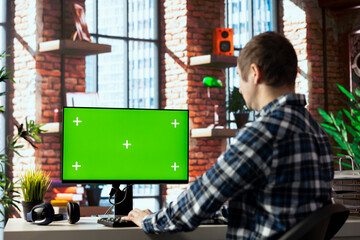 Poster - Man in home office using mockup computer, preparing presentation slides, adjusting layouts. Employee finishing company project, writing summaries, saving files on green screen PC, uploading materials