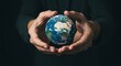 © Alamin Islam Adi  - Hands gently holding a miniature earth globe