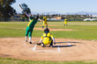 © Wavebreak Media - White male batter swinging bat in uniform at home plate by chain-link fence, copy space