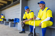 © Wavebreak Media - Diverse male teammates laughing and chatting while holding bat and glove at baseball dugout