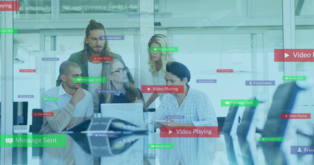 Poster - Collaborating five professionals showing software features in glass office, with laptops and tablet