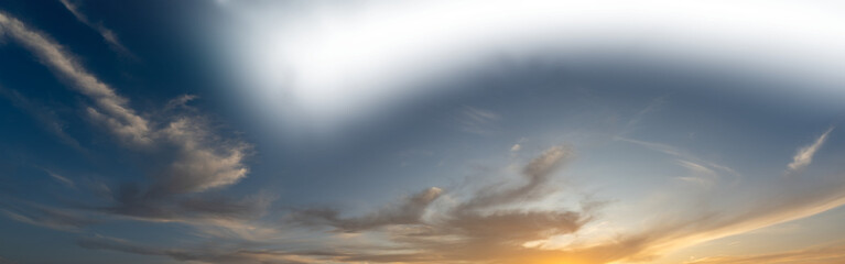 Wall Mural - Late day sky as the setting sun colors some clouds with a partially transparent sky
