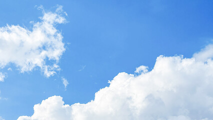 bright white cumulus clouds floating in a clear blue summer sky. blue sky with clouds. soft white cl