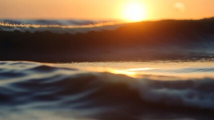 Wall Mural - close-up view of ocean waves at sunset, warm golden light reflecting on water surface. tranquil and 