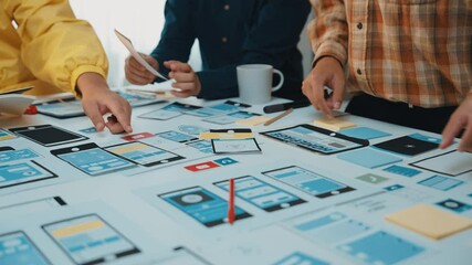 Poster - A diverse team of professionals engages in a collaborative user interface design session, analyzing digital prototypes and discussing strategies in a modern office environment. SACTR