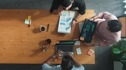 Poster - Smart project manager calling phone while diverse team brainstorm idea and looking at financial statistic at tablet at meeting table. Diverse business people planning marketing strategy. Convocation.