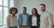 © mlangsen - Diverse team smiling, in office by a window