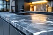 © Rasel Ai - Closeup of a dark marble kitchen countertop with bright accent lighting