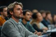 © Reema - New generation of entrepreneurs in a business marketing class, group of young businessmen learning and taking notes from a successful entrepreneur, Generative AI