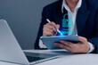 © khunkornStudio - Business data security concept. A person entering a password on a tablet. Protecting online information, confidential data, and smart access. Data breach prevention and secure system.