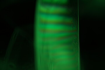 Fototapete - Green liquid surface, green on black 