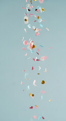 Poster - Falling confetti, pink, blue, gold, on light-blue background, evokes celebration, joy, festive mood, ideal for party invitations or celebratory designs