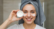 © SkyPix - Young Woman Applying Face Cream in Bathroom