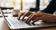 © lemonarts - Close-up of hands typing on a laptop keyboard, showcasing work, communication, or online activity.