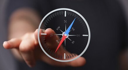 Poster - Hand pointing at a digital compass, showing navigation and direction. Ideal for business, technology, and travel concepts.
