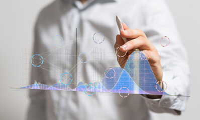 Poster - Stock photo of a businessman using a stylus to interact with projected data charts showing growth and analytics.