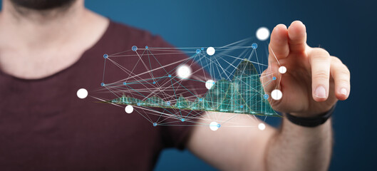 Poster - Person using touch interface to interact with a 3D model of a smart city's network.