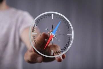 Poster - Person using a digital compass, showcasing navigation and direction. Ideal for business, technology, and travel.