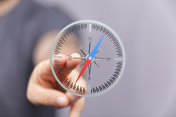 Poster - Person using a digital compass for navigation.  Modern technology, direction, guidance.
