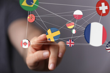Poster - Image of a hand interacting with a network of interconnected country flags, symbolizing global collaboration and international business.