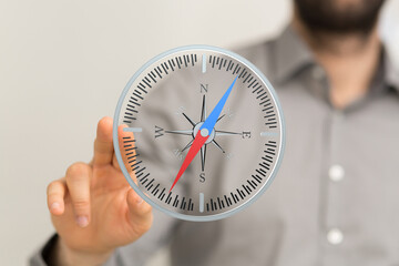 Poster - A businessman uses a digital compass, symbolizing strategic planning, direction, and guidance in business.