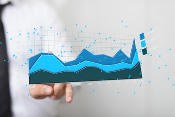 Poster - Stock photo of a businessman reviewing a financial graph, showcasing data analysis and growth.