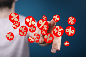 Poster - Image of a hand interacting with floating percentage symbols, ideal for finance, discount, and sale concepts.