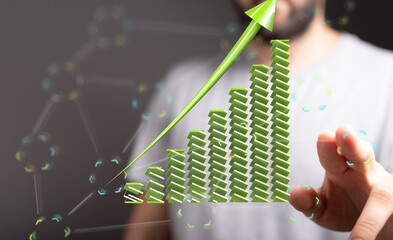 Poster - Stock photo of a man presenting a growing bar chart, symbolizing business growth and success.