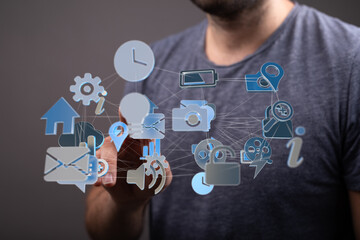 Poster - A man interacts with a holographic interface showcasing various digital icons and connections.