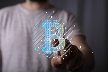 Poster - Close-up of a person's hand interacting with a digital Bitcoin symbol, highlighting cryptocurrency technology.
