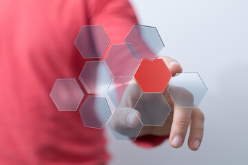 Poster - Abstract image of a hand interacting with a digital hexagon network.  Modern technology concept.