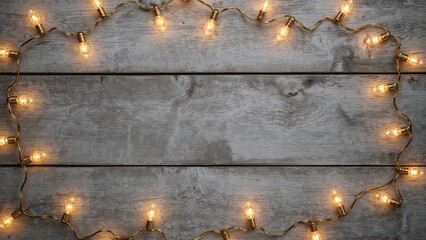 Poster - Holiday ambiance created by vibrant glowing lights and garlands arranged on a weathered wooden board. Aerial shot with space for content.