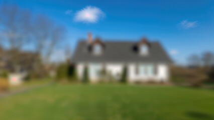Wall Mural - softly blurred image of a village dwelling's outer wall with a vivid blue sky, including plenty of b