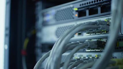 Poster - Close Up Of Modern Gray Network Servers With White Cables And Blinking Lights In A Dimly Lit Environment