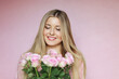© Anneleven - Floral elegance, blooming beauty, joyful celebration. Beautiful woman with blonde hairstyle and blue eyes, natural makeup, holding a bouquet of pink roses