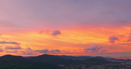 Wall Mural - a breathtaking sunset paints the sky in vivid hues of orange and blue over a coastal town, with lush