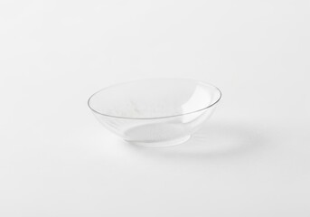 Poster - Clear Glass Bowl on White Background - A clean, empty, transparent glass bowl sits on a bright white background. The conveys simplicity, purity, minimalism, elegance, and clarity