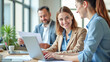 © Radorog. - a successful business team in an office with laptops