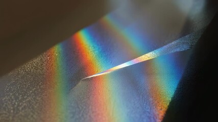 Poster - Sunlight is diffracting through a wet textured surface, creating a beautiful rainbow effect with vibrant colors and interesting light patterns